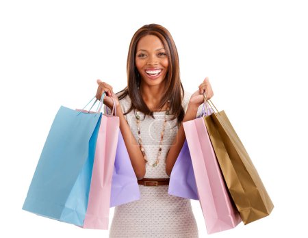 Photo for Shopping makes me happy. Portrait of a happy ethnic woman holding lots of shopping bags and looking excited - Royalty Free Image