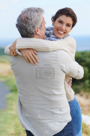 Photo for Love in the sunshine. A loving couple hugging each other affectionately outdoors - Royalty Free Image