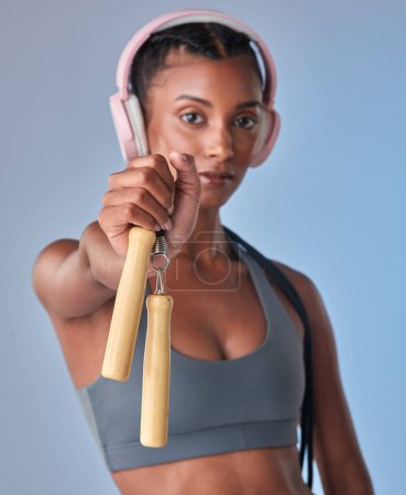 Photo for You wont regret working out with this. Studio shot of a fit young woman working out with jump rope against a grey background - Royalty Free Image