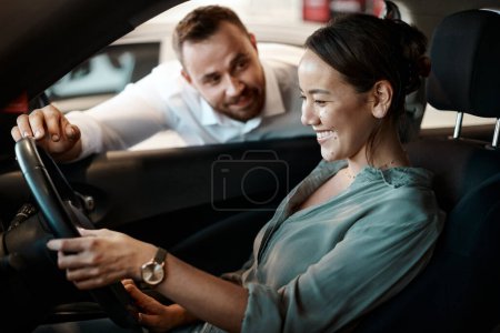 Photo for I hope youre happy with this car. a young woman testing out a new car shes about to purchase - Royalty Free Image
