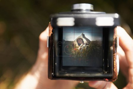 Photo for Picture perfect. Someone holding a camera with the image of a woman in the viewfinder - Royalty Free Image