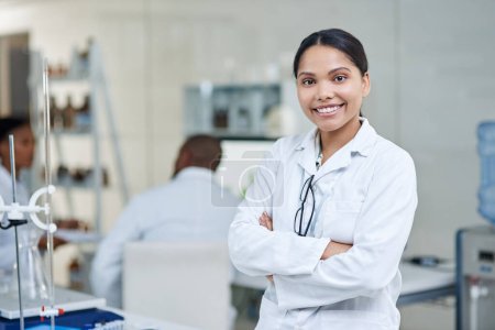 Photo for Making marvellous discoveries about the world through science. Portrait of a young scientist standing with her arms crossed in a lab - Royalty Free Image