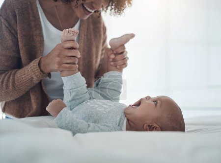 Photo for When you have mommys love, you need nothing else. a young woman playing with her adorable baby girl on the bed at home - Royalty Free Image