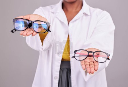 Photo for Glasses in hands, choice and vision with optometrist, prescription lens and frame isolated on studio background. Person with eyewear, ophthalmology and health insurance, product to help with eyesight. - Royalty Free Image