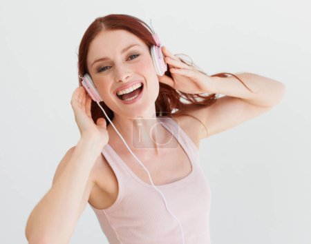 Photo for Woman, headphones and studio portrait with smile for music, streaming subscription or podcast by background. Isolated girl, student or model with happiness for audio, sound and internet radio by wall. - Royalty Free Image