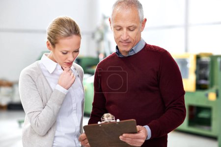 Photo for They take their job seriously. two factory managers standing with a clipboard - Royalty Free Image