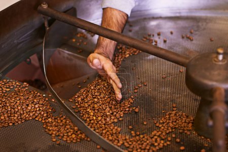 Photo for Roasted to perfection. a machine grinding and roasting coffee beans - Royalty Free Image