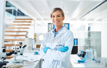 Photo for Dedicated to discovering something new. Portrait of a mature scientist standing with her arms crossed in a lab - Royalty Free Image
