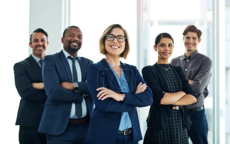 Photo for Well show you how to put the power of synergy to work. Portrait of a diverse group of businesspeople standing together in an office - Royalty Free Image