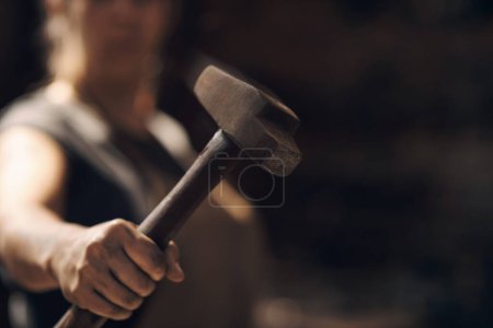 Photo for Grab your hammer, were going forging. a woman holding a hammer while working at a foundry - Royalty Free Image