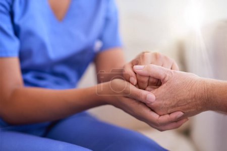 Photo for Im here to help lessen your burdens. a nurse holding a senior womans hands in comfort - Royalty Free Image