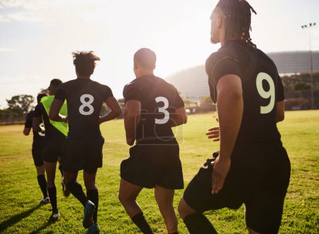 Photo for Running keeps us on top of our game. an unrecognizable group of sportsmen warming up before playing rugby during the day - Royalty Free Image