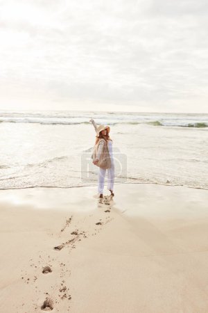 Photo for There is sunshine in my soul today. Portrait of a young woman standing with her arms outstretched at the beach - Royalty Free Image