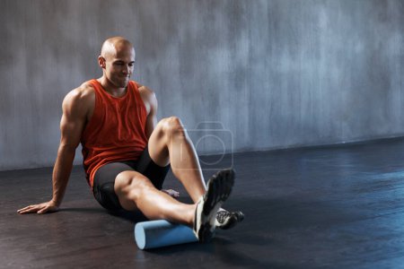 Photo for Foam roller , mockup of man training or workout and at gym. Personal trainer or fitness pain relief, exercise and motivation. Athlete or sportsman, male person stretching or warm up and focus. - Royalty Free Image