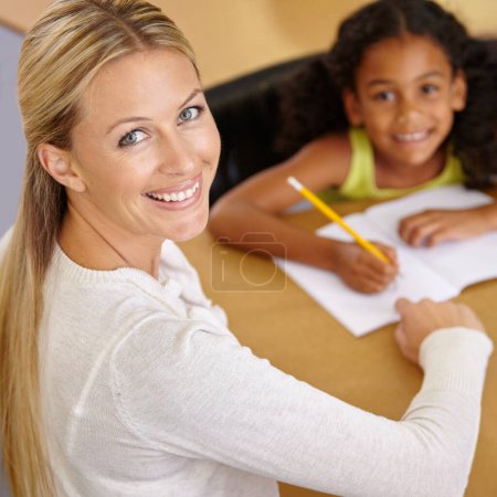 Photo for Private tutor, portrait and child to learn in class at desk at school for an education with support. Woman, teaching and writing student with smile for learning or reading in the classroom for study - Royalty Free Image