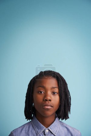 Photo for Just be who you are. Studio portrait of a young boy standing against a blue background - Royalty Free Image