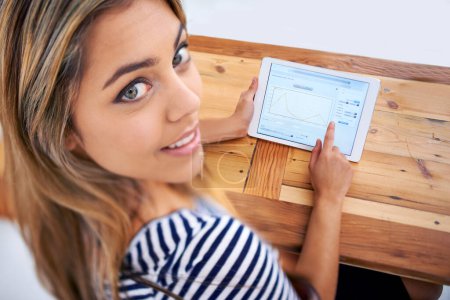 Photo for The stats are in our favour. A cropped portrait of a beautiful young woman using a tablet at her desk - Royalty Free Image