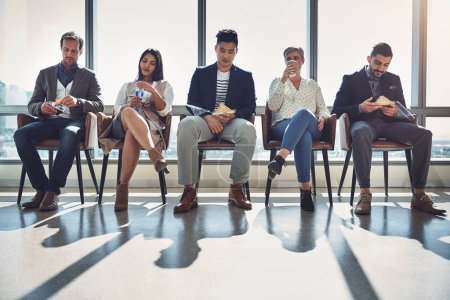 Photo for Its break time. a group of businesspeople taking a break while sitting in line in an office - Royalty Free Image