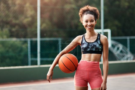 Photo for This is my comfort zone. an attractive young sportswoman standing on the court alone and holding a basketball during the day - Royalty Free Image