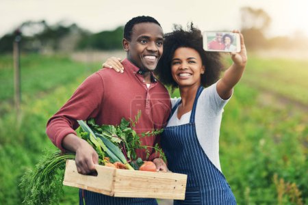 Photo for Because a healthy life is a happy life. an affectionate young couple taking selfies while working on their farm - Royalty Free Image