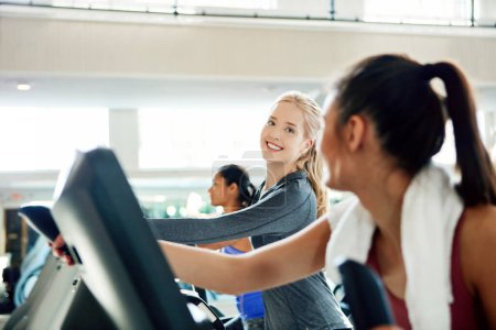 Photo for Ill race you. attractive young women working out on treadmills at the gym - Royalty Free Image
