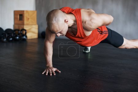 Photo for Training, muscle endurance and strong man doing push up for healthy lifestyle, strength development or health club commitment. One arm pushup, motivation and male athlete workout, fitness or exercise. - Royalty Free Image