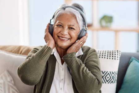 Its music for the soul. Cropped portrait of an attractive senior woman listening to music at home
