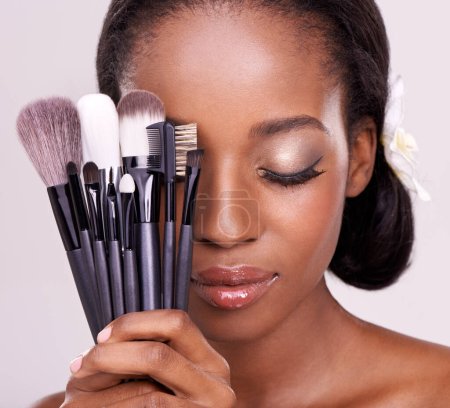 Photo for Cosmetic tools, makeup and black woman with brushes, face on studio background with application tool. Skincare, beauty and cosmetics, facial skin care model with luxury contour tools and closed eyes - Royalty Free Image