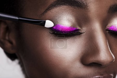 Photo for When in doubt wing it out. Studio shot of a beautiful young woman applying eye makeup - Royalty Free Image