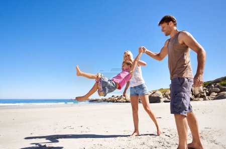 Photo for Theyre a family of beach lovers. a happy young family enjoying a walk on the beach - Royalty Free Image