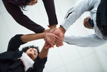 Photo for Hard work beats talent when talent fails to work hard. a group of unrecognizable businesspeople joining their hands together in a huddle - Royalty Free Image