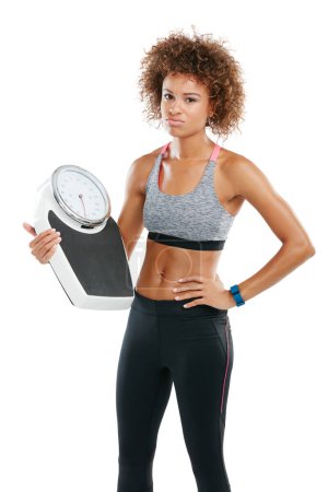 Photo for No one said it would be easy....Studio portrait of a fit young woman holding a scale against a white background - Royalty Free Image