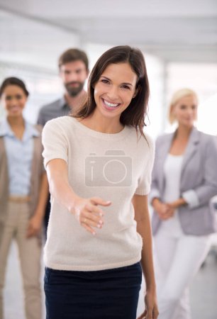 Photo for Looking forward to having you on board. an attractive businesswoman with her hand extended to the camera in greeting - Royalty Free Image