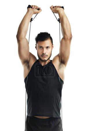 Photo for Train like you mean it. Studio shot of a young man working out with a resistance band against a white background - Royalty Free Image