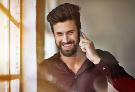 Photo for This call just made my day. Cropped portrait of a businessman making a call in his office - Royalty Free Image