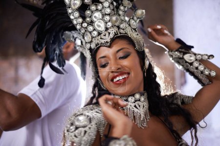 Glamourous dancing queen. a beautiful samba dancer performing in a carnival with her band