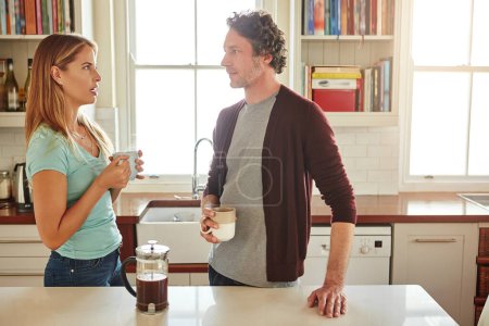 Photo for Its about long conversations which always seems too short. a couple chatting over coffee at home - Royalty Free Image