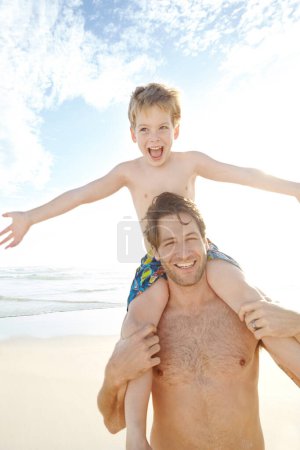 Photo for Sun and excitement. a young father carrying his son on his shoulders at the beach - Royalty Free Image