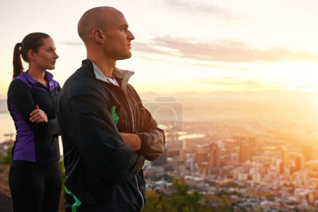 Photo for Psyched for their run. a young couple looking at the view while out for a run - Royalty Free Image