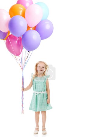Foto de Globos para tu día especial. Estudio de una linda niña sosteniendo un montón de globos sobre un fondo blanco - Imagen libre de derechos