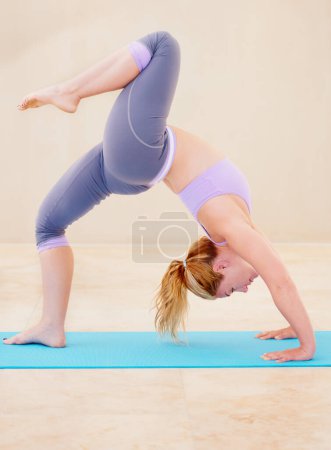 Photo for Fitness, yoga and woman stretching body on mat for flexibility, wellness and balance in studio. Sports, healthy workout and female person in gym class for exercise training and pilates in wheel pose. - Royalty Free Image
