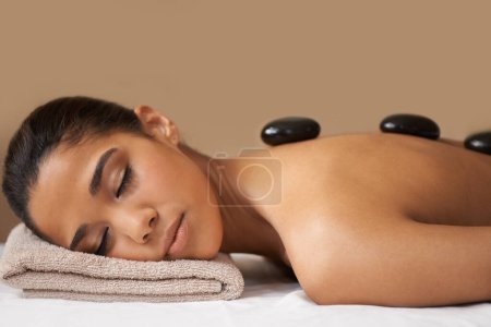 Photo for Woman, rock or back massage in spa to relax for zen, sleeping or wellness physical therapy in resort. Relaxed girl client in beauty salon to exfoliate for luxury skincare healing treatment or detox. - Royalty Free Image