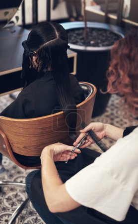 Photo for Were keeping the length but taking off a little. a hairstylist cutting a clients hair in a salon - Royalty Free Image