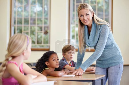 Photo for Portrait, woman and happy teacher in class helping students in classroom. Teaching, female educator and smile of person with children learning in primary school for education, studying or knowledge - Royalty Free Image