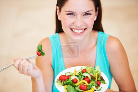 Photo for Woman, portrait and eating a healthy salad with vegetables, nutrition and health benefits. Face of a happy female person on a nutritionist diet with vegan food for weight loss, wellness or detox. - Royalty Free Image