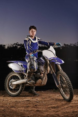 Ready to take on anything. Portrait of a young motocross rider posing on his bike