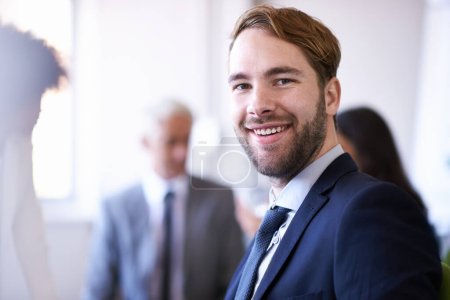 Foto de Apasionado por los negocios. Vista recortada de un joven empresario sonriendo mientras estaba en una reunión - Imagen libre de derechos