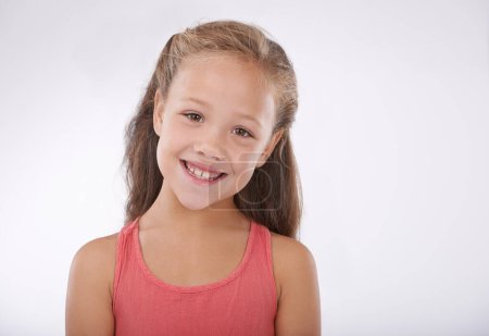 Photo for Shes so happy and carefree. Portrait of a happy little girl in studio - Royalty Free Image