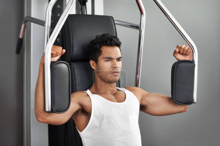 Foto de Mantenerse enfocado y motivado. Un joven hombre étnico ejercitándose en el gimnasio - Imagen libre de derechos