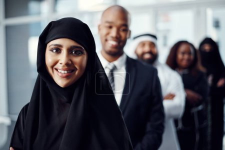 Photo for I love it when a plan comes together. Cropped portrait of an attractive young arabic businesswoman standing at the head of a line of her colleagues - Royalty Free Image